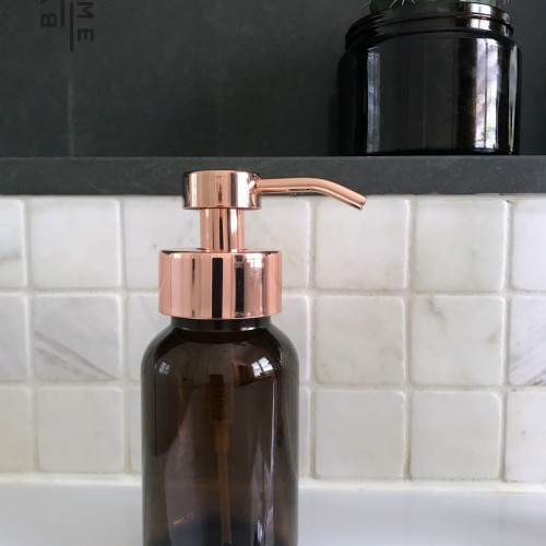 Glass foaming soap dispenser with rose gold pump
